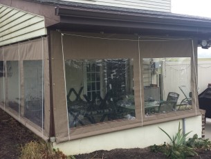 Beige fabric porch curtains with clear vinyl panels