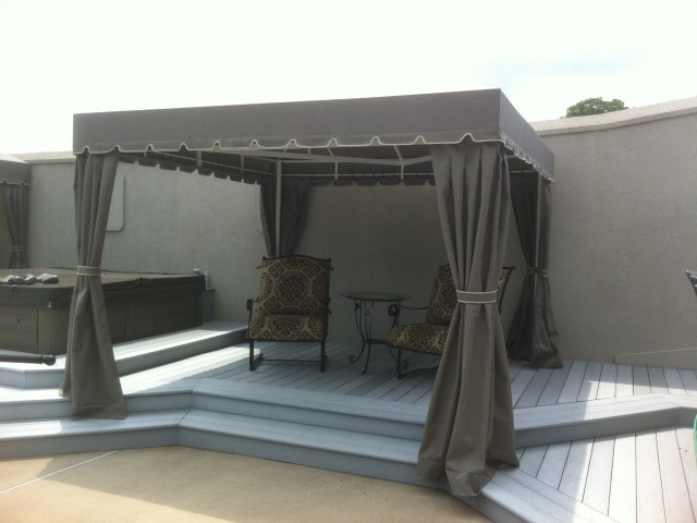 Freestanding poolside cabana with corner curtains