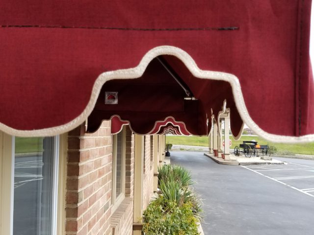 Multiple commercial window awnings installed on a restaurant