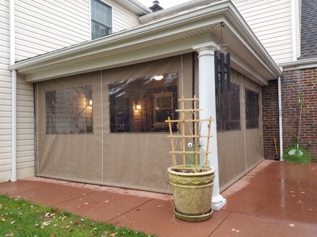 Porch enclosure with clear vinyl panels