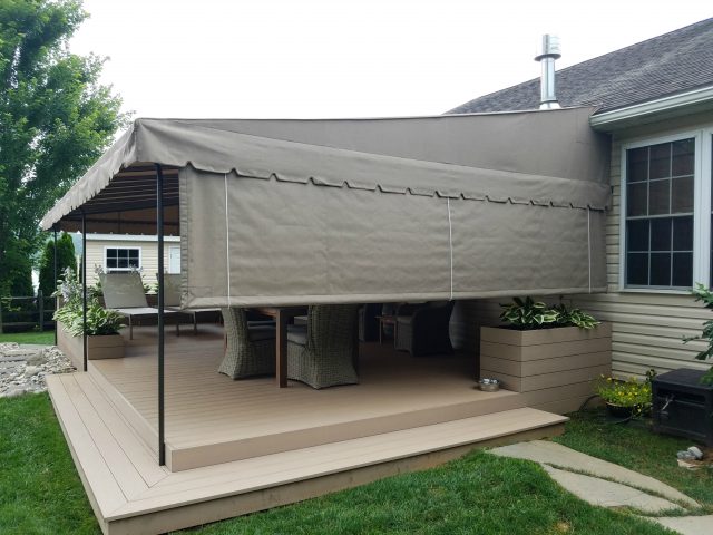 Beige deck canopy with drop curtain