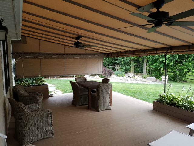 Beige deck canopy with drop curtain and ceiling fans