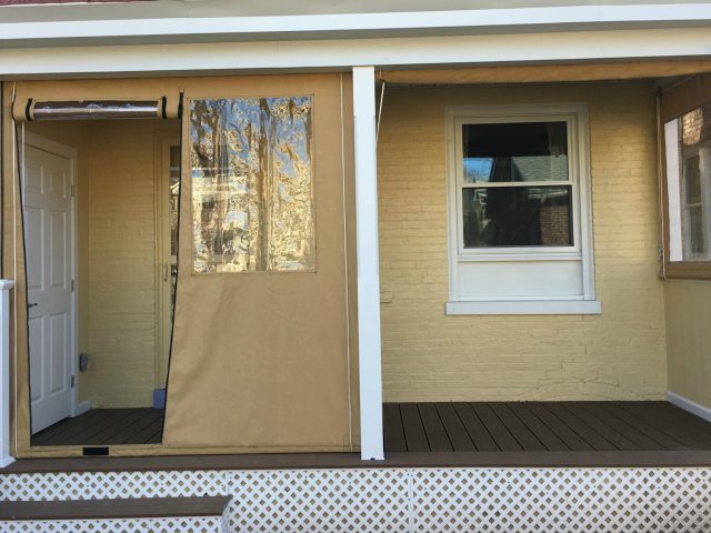 Clear Vinyl Drop Curtains on a porch - zippered door - Sunbrella fabric