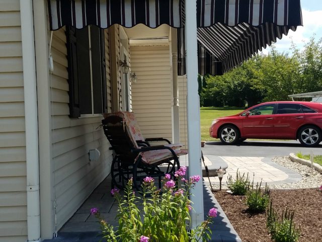 Porch Awning with a pleated drop curtain black and white striped Sunbrella fabric