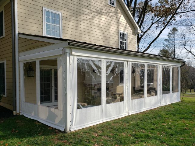 clear vinyl drop curtain enclosure on a residential porch roll up drapes blinds sunbrella fabric canvas