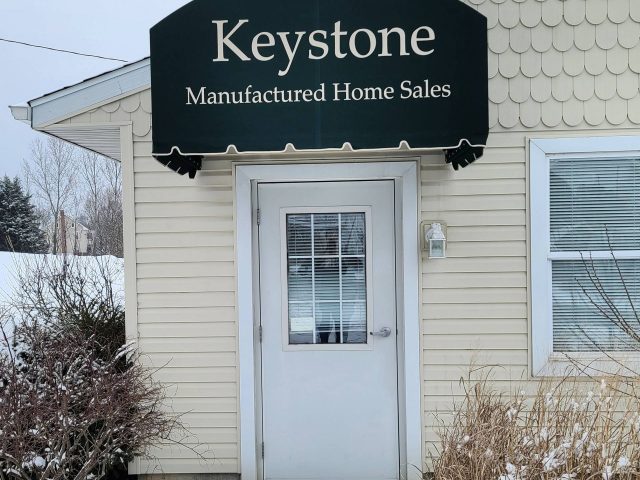 Keystone Manufactured Homes - commercial entracne awning doorhood sunbrella fabric lettering