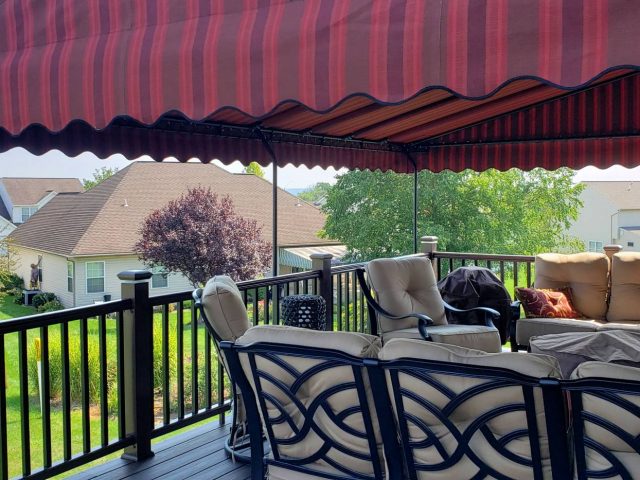 Beautiful Sunbrella fabric canopy installed over a deck. Wave scallop.